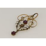 9ct yellow gold pendant of Art Nouveau style set with two 4mm diameter garnets, weight 1.5g