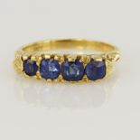 Yellow gold (tests 18ct) sapphire boat shaped ring, four variously sized sapphires principle