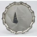 Small silver salver with a pie- crust border standing on three feet, engraved in the centre "G.R.,