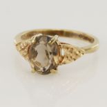 9ct yellow gold smokey quartz dress ring, quartz measures 9 x 7mm, finger size M/N, weight 2.7g.