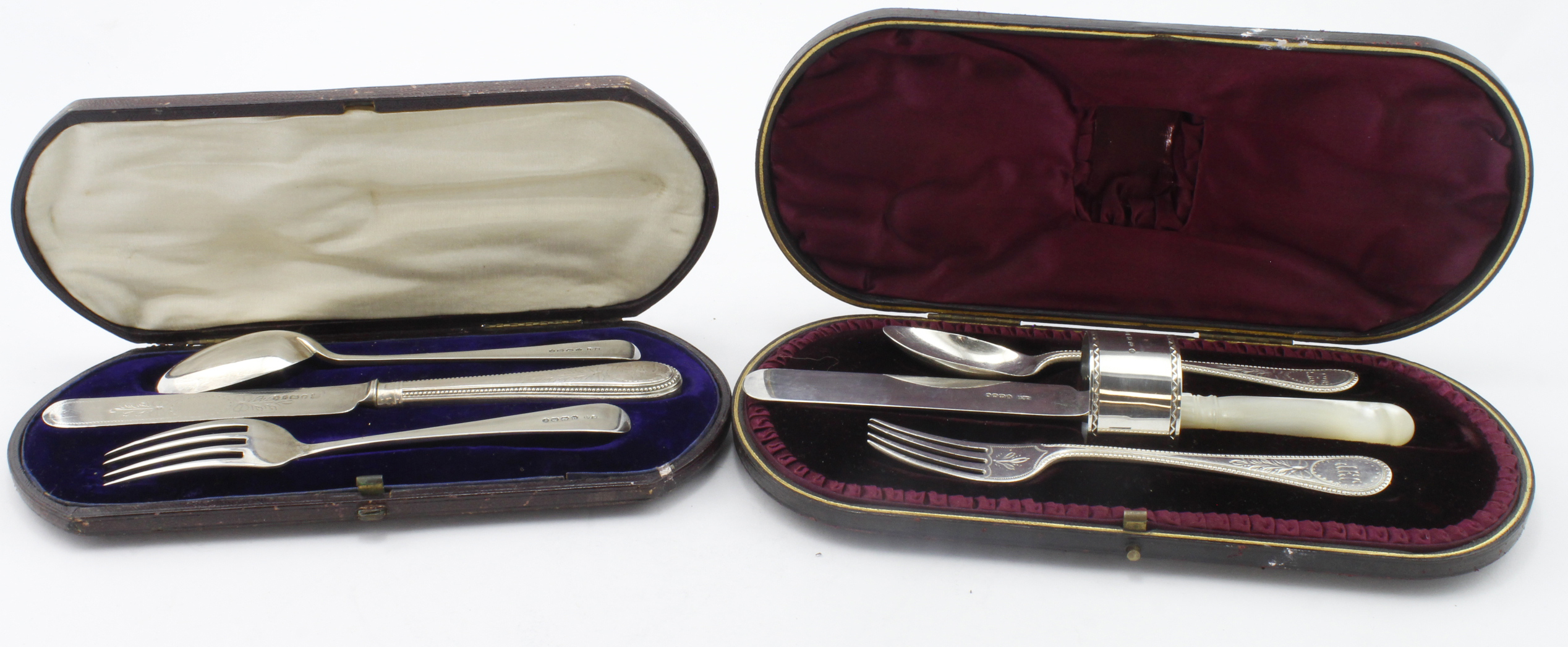 Two boxed silver Christening sets comprising knife, fork & spoon and knife, fork, spoon & napkin