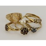 Six 9ct gold dress rings, stones include synthetic moissanite, cultured pearl, smokey quartz, carved