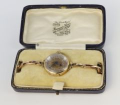 9ct yellow gold mechanical wrist watch (working when catalogued) on 9ct rose gold sprung bracelet