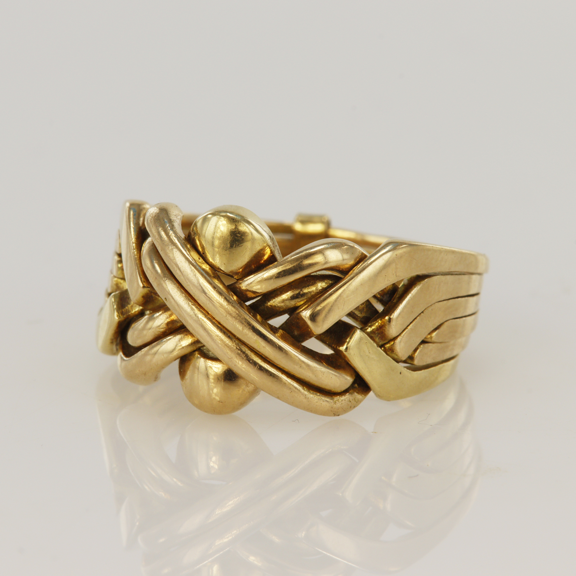 Yellow gold (tests 14ct) six banded puzzle ring, head width 13mm, finger size W/X, total weight 9.