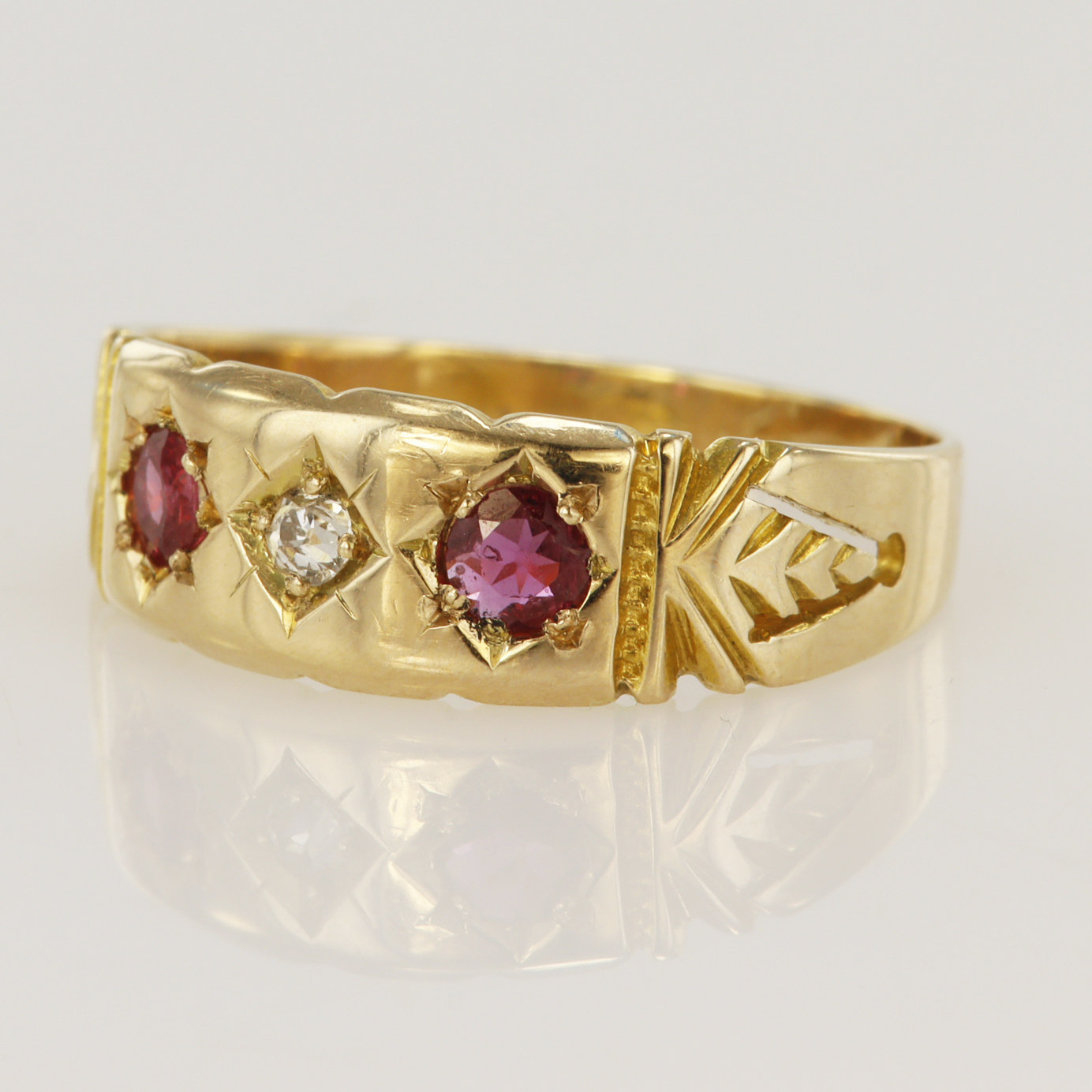 Yellow gold (tests 18ct) antique diamond and ruby ring, one old cut diamond approx. 0.03ct, two
