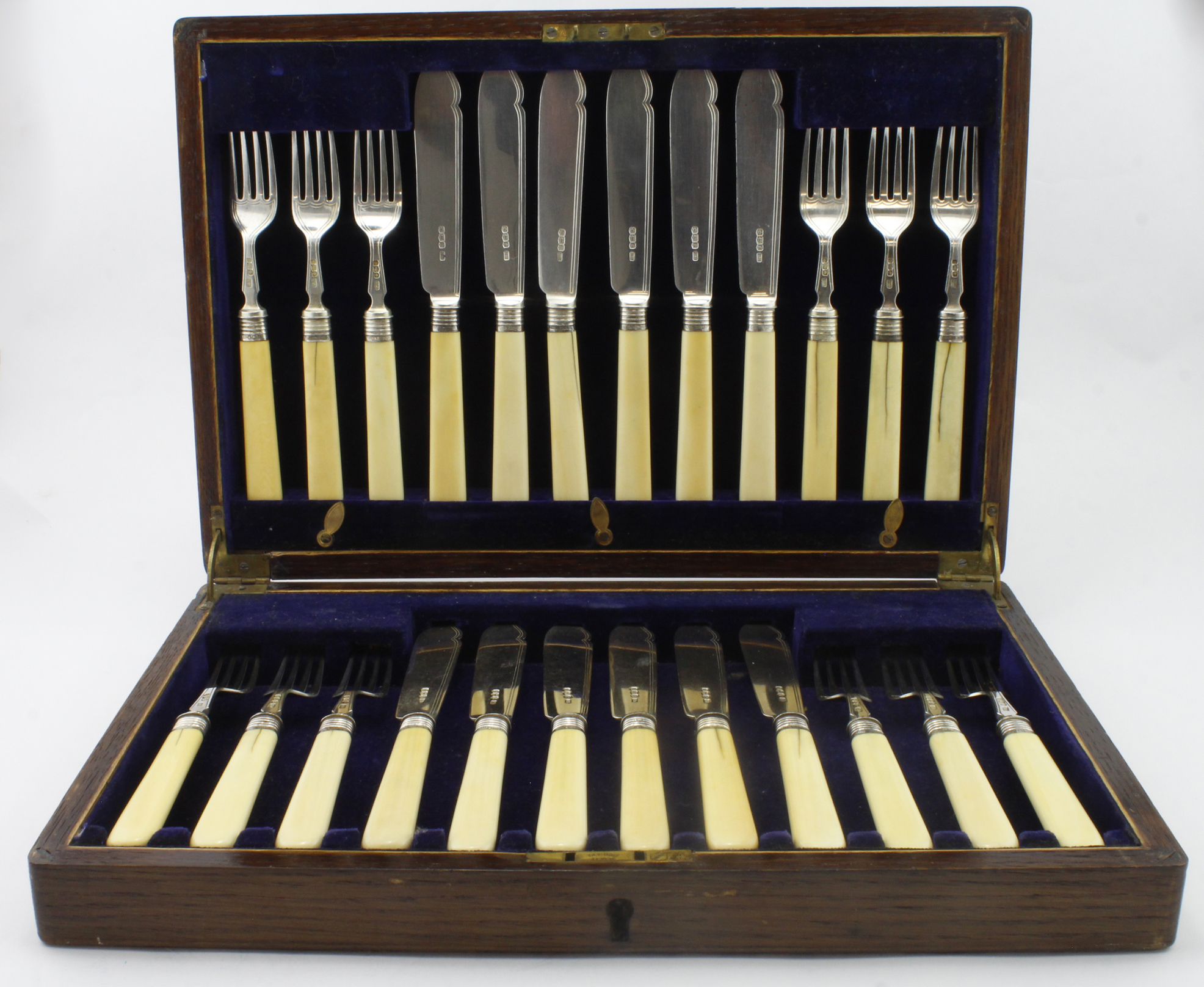 Boxed set of twelve bone handled and silver fish knives and forks, eleven of the handles show some