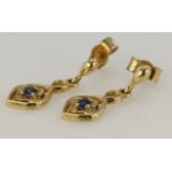 9ct yellow gold drop earrings set with a single round sapphire in a floral setting, post and