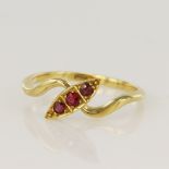 Yellow gold (tests 18ct) synthetic ruby trilogy ring, navette seting measures 12 x 5mm, finger