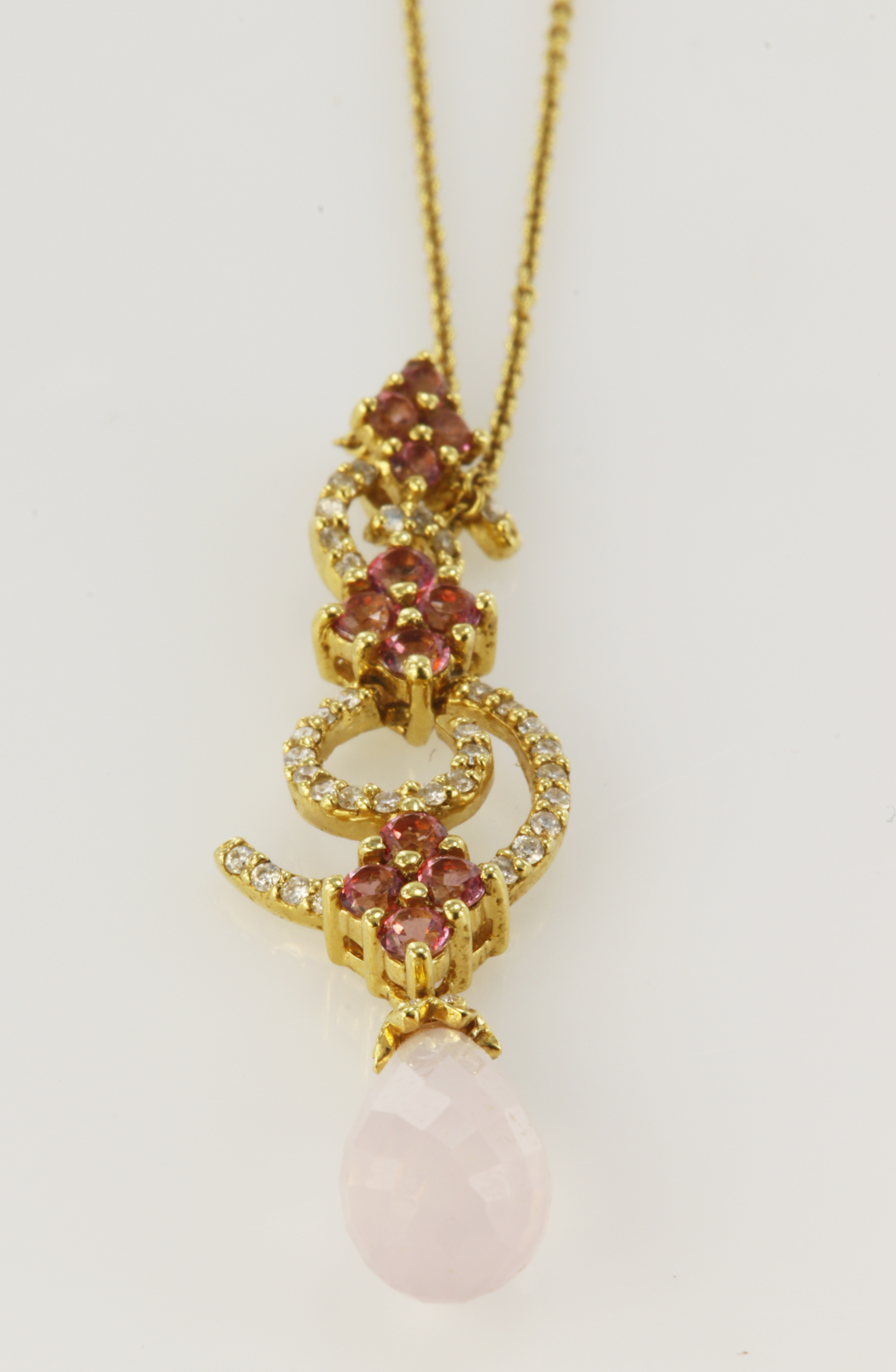Lovely 18ct yellow gold pendant with two diamond set spirals, featuring pink topaz and a rose quartz