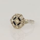 White gold (tests 18ct) diamond and onyx cluster ring, eleven round cut diamonds TDW approx. 0.28ct,