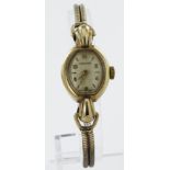 Ladies 9ct cased Longines manual wind wristwatch, circa 1951. The creamed dial with gilt Arabic