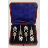 Boxed set of four silver plated spoons with scorpion shaped handles.