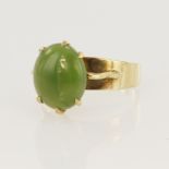 9ct yellow gold dress ring set with an oval jade cabochon measuring approx. 12mm x 10mm in a