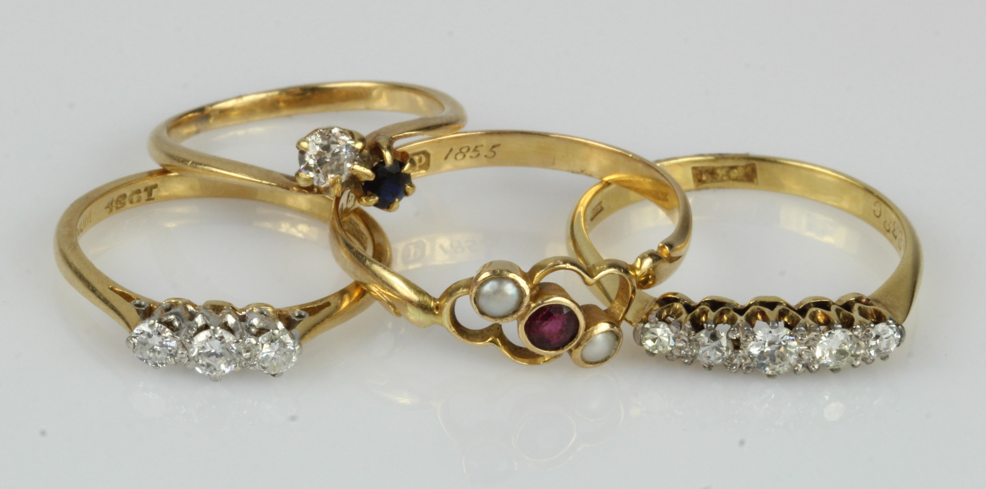 Four 18ct gold/tests 18ct gold rings, to include a antique ruby and seed pearl trilogy ring,