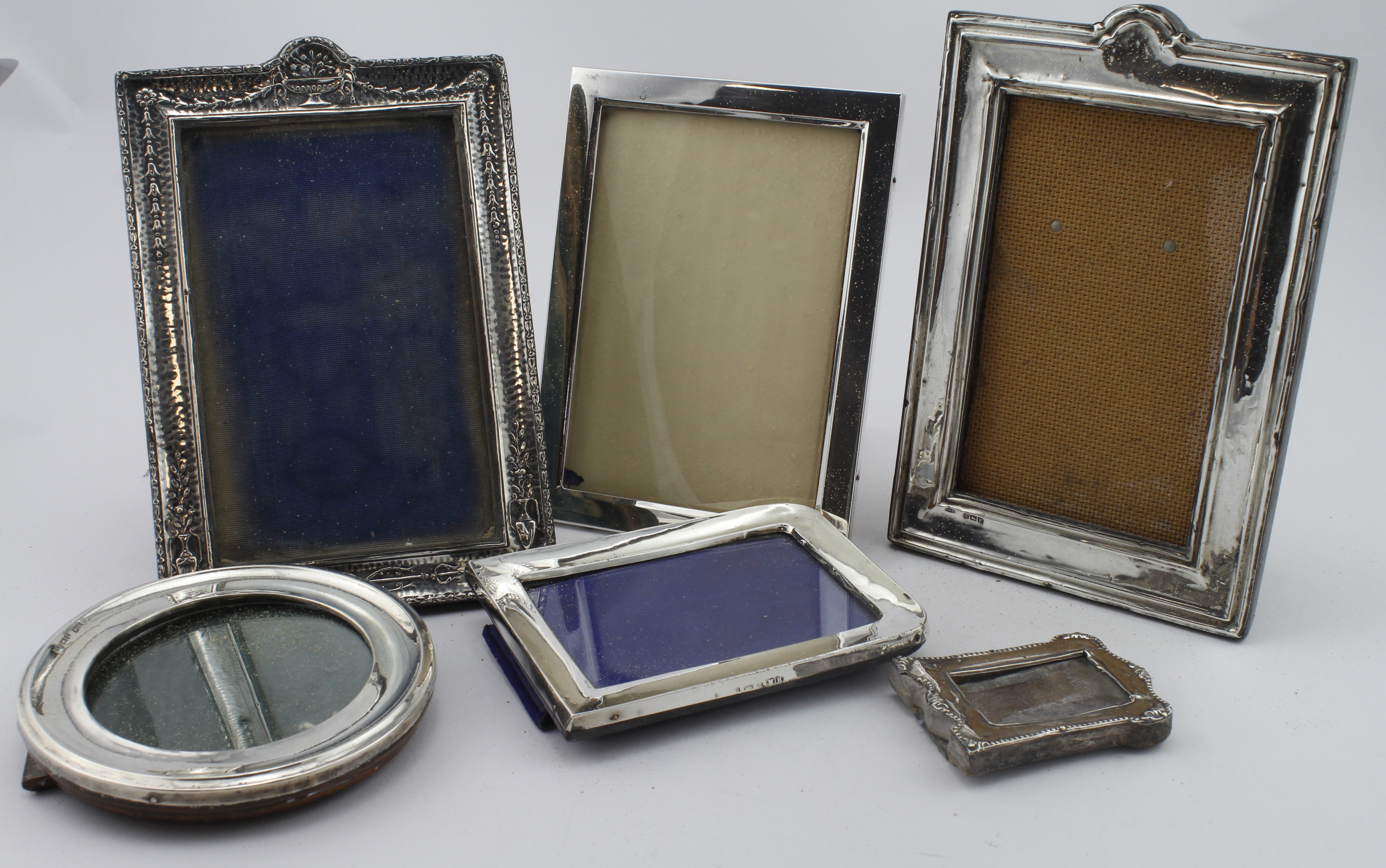 Six silver mounted photo frames, five bear older British hallmarks and one is marked "Sterling