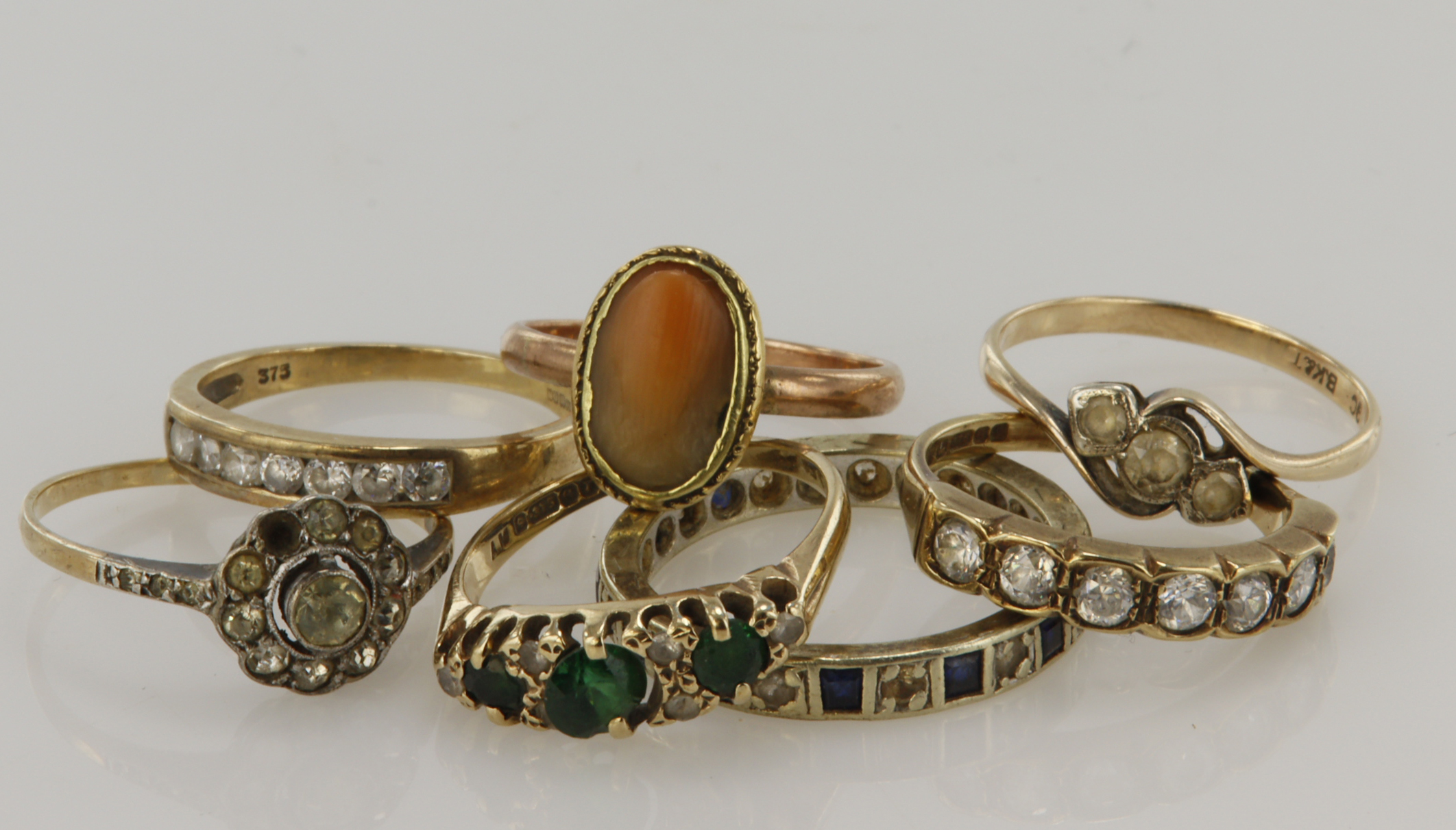 Seven 9ct gold/tests 9ct rings, stones include CZ, paste and shell, finger sizes Lx2, Nx2, O, P, all