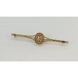 Yellow gold (tests 18ct) antique pink tourmaline and seed pearl bar brooch, one oval tourmaline