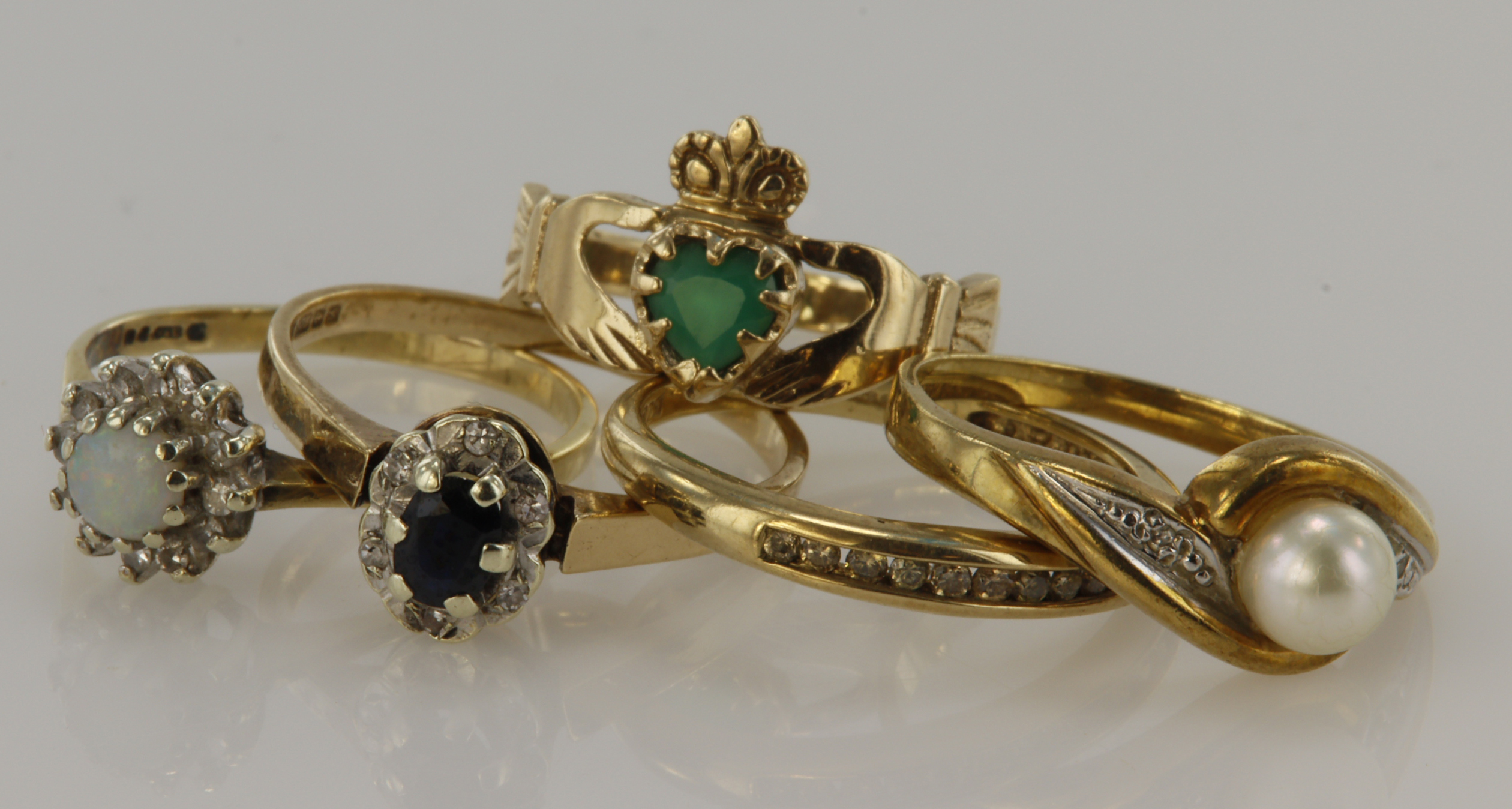 Five 9ct gold/tests 9ct dress rings, stones include diamond, champagne diamond, sapphire, opal,