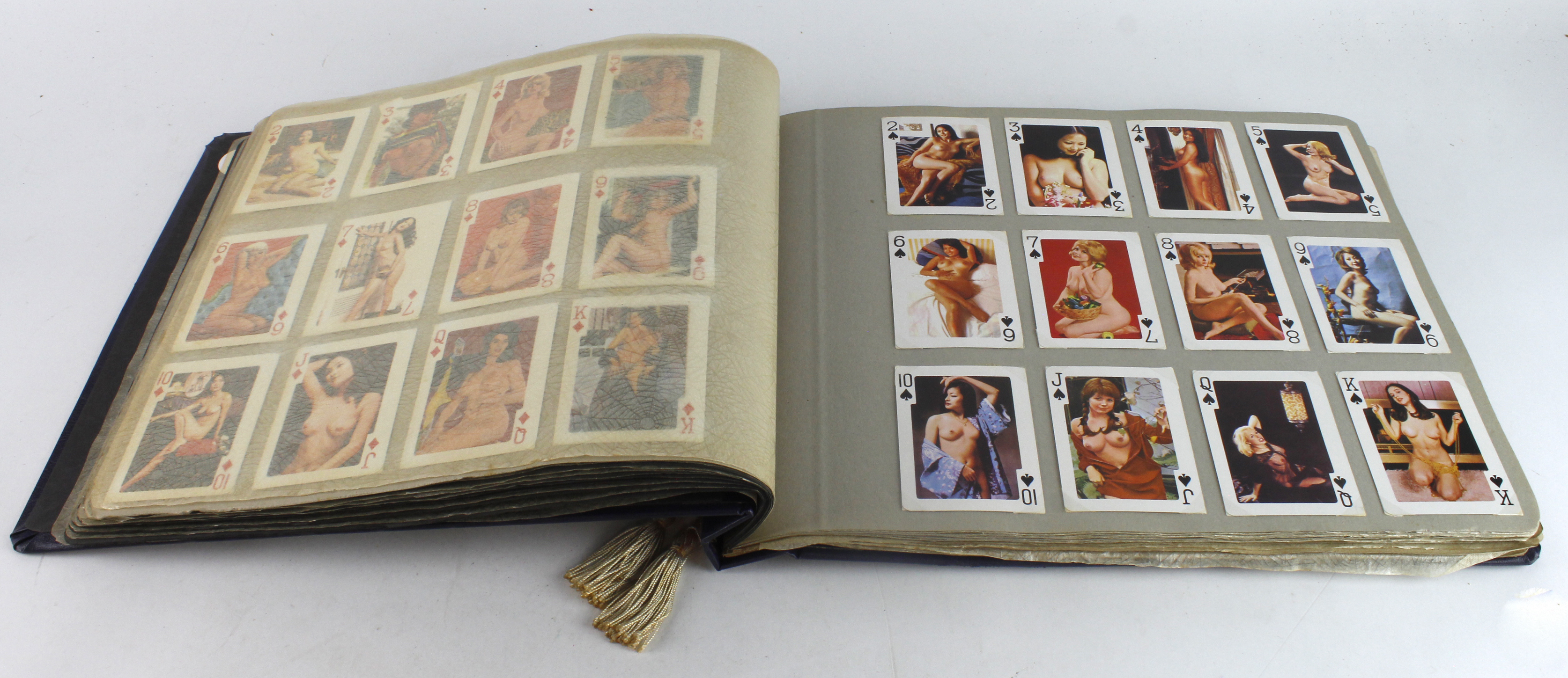 Large album with playing card sets contained in photo corners, erotic material, view with caution!