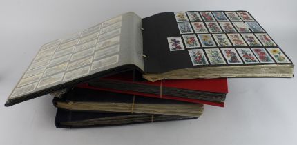 Collection of approx 98 complete sets contained in photo corners within   4 large albums, mainly