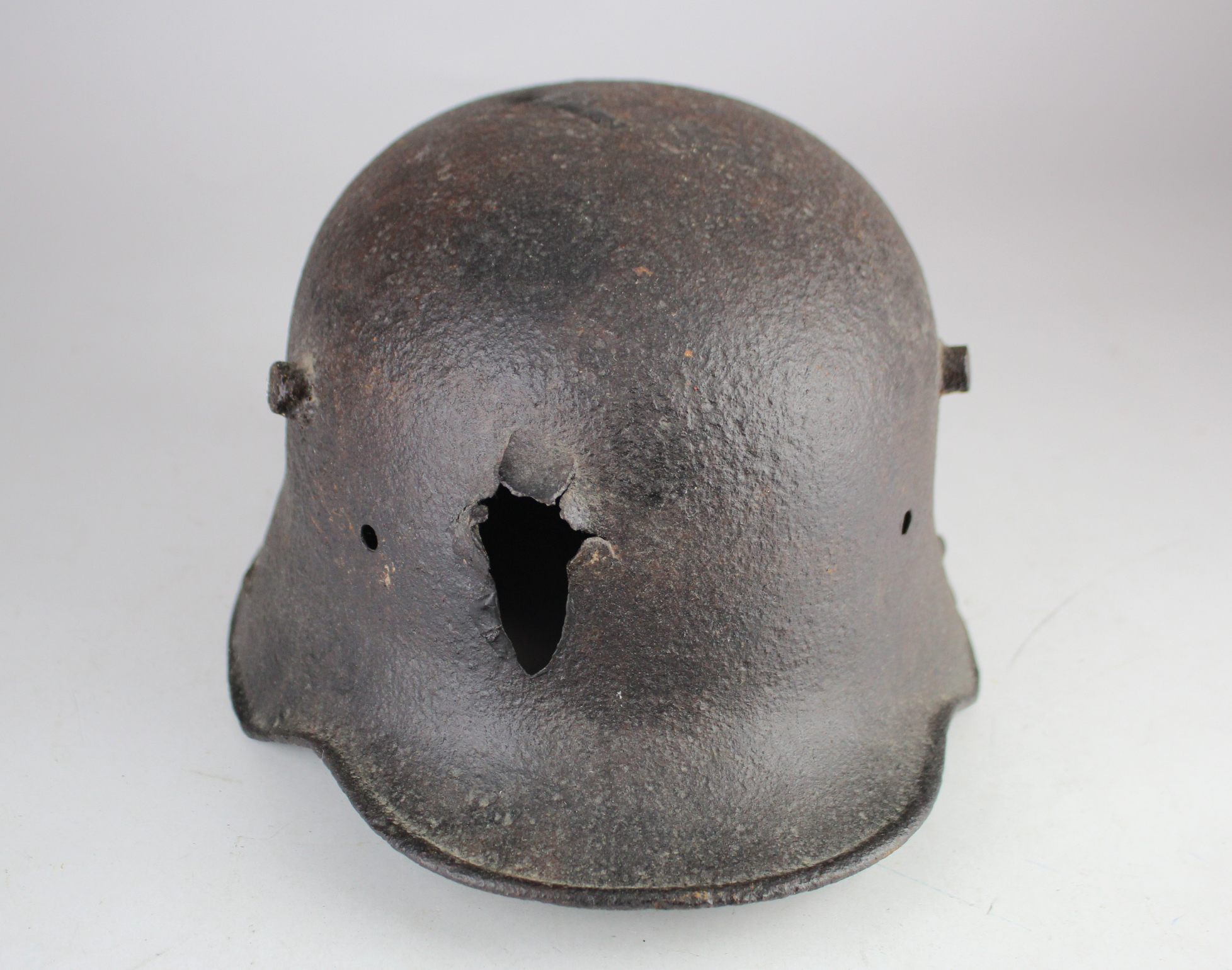 German WW1 1916 pattern steel helmet with bullet hole through the top and through the front found on