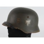 German Wehrmacht M35 double decal combat helmet, complete with liner and chin strap, ET64 to skirt.