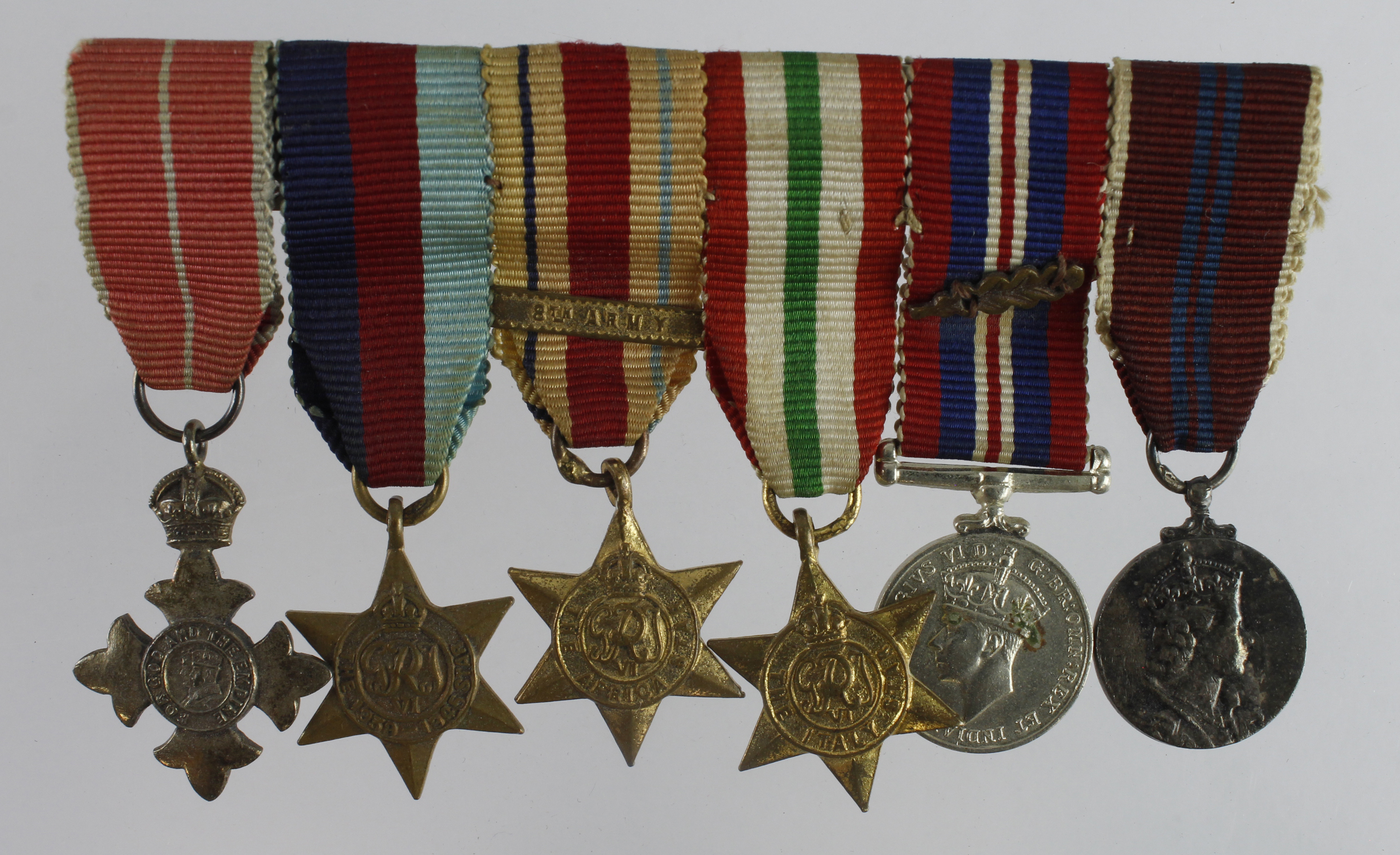 Minature Medal group mounted as worn - OBE (Mily), 1939-45 Star, Africa Star + 8th Army clasp, Italy