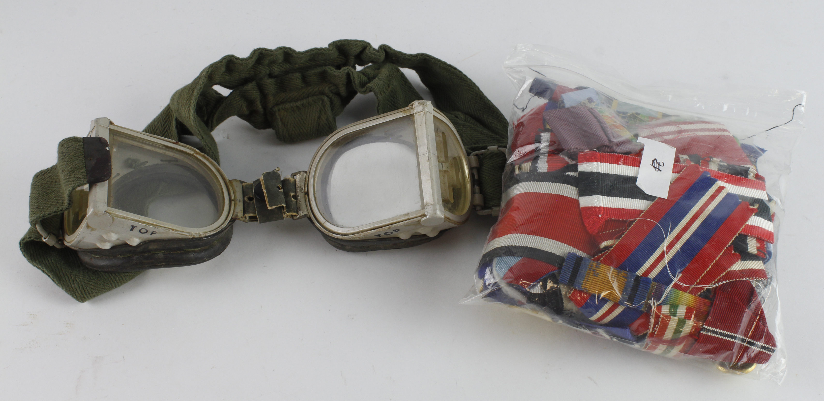 Bag of various medal ribbons and a pair of military (?) goggles
