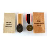 German WW2 West Wall medal in original packet with War Merit medal in original packet.