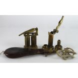 Sundry reloading brass tools, leather flask, nozzle, lanyard