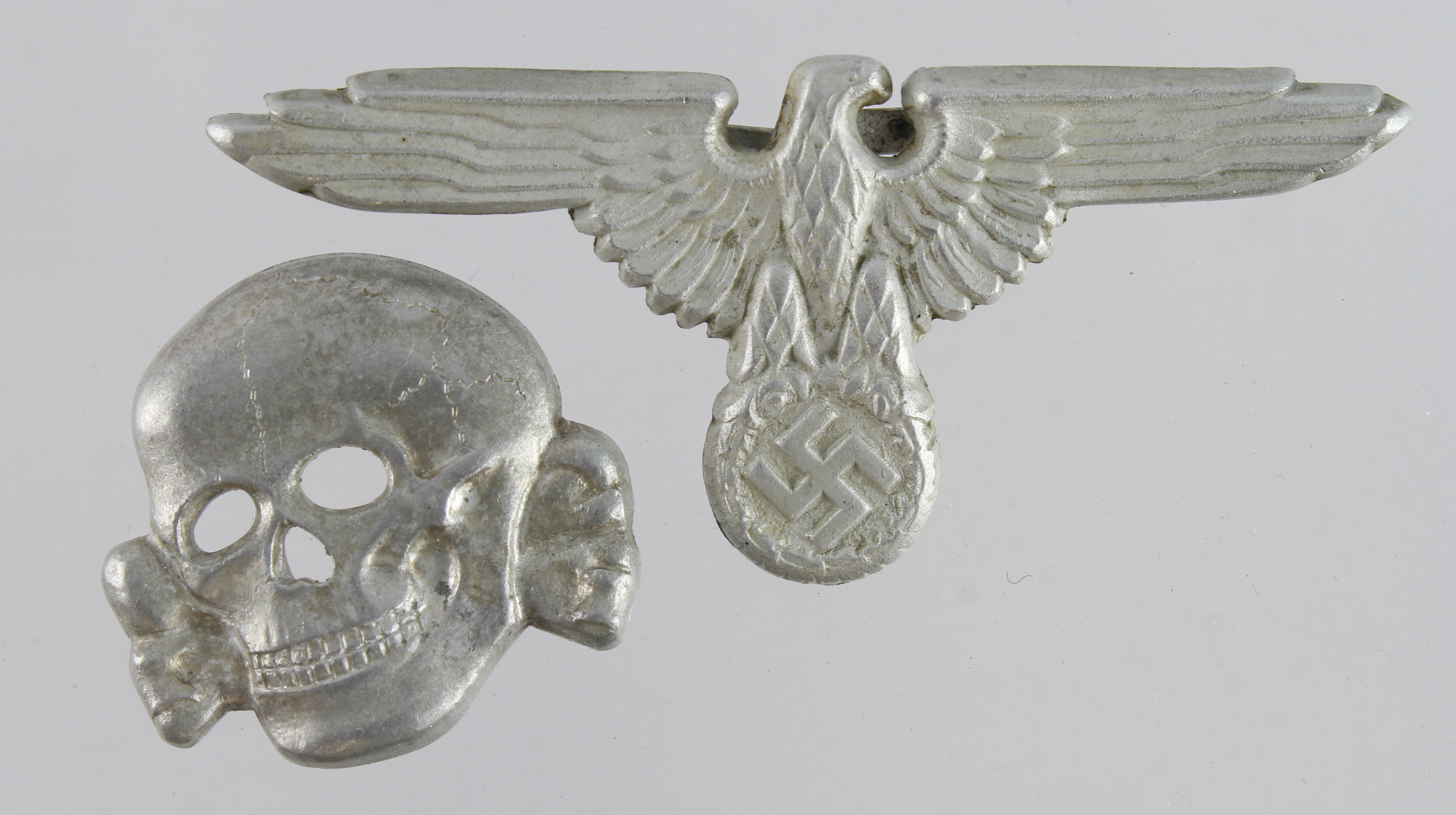 German SS officers hat badge with deaths head scull both maker marked and dated 1942.