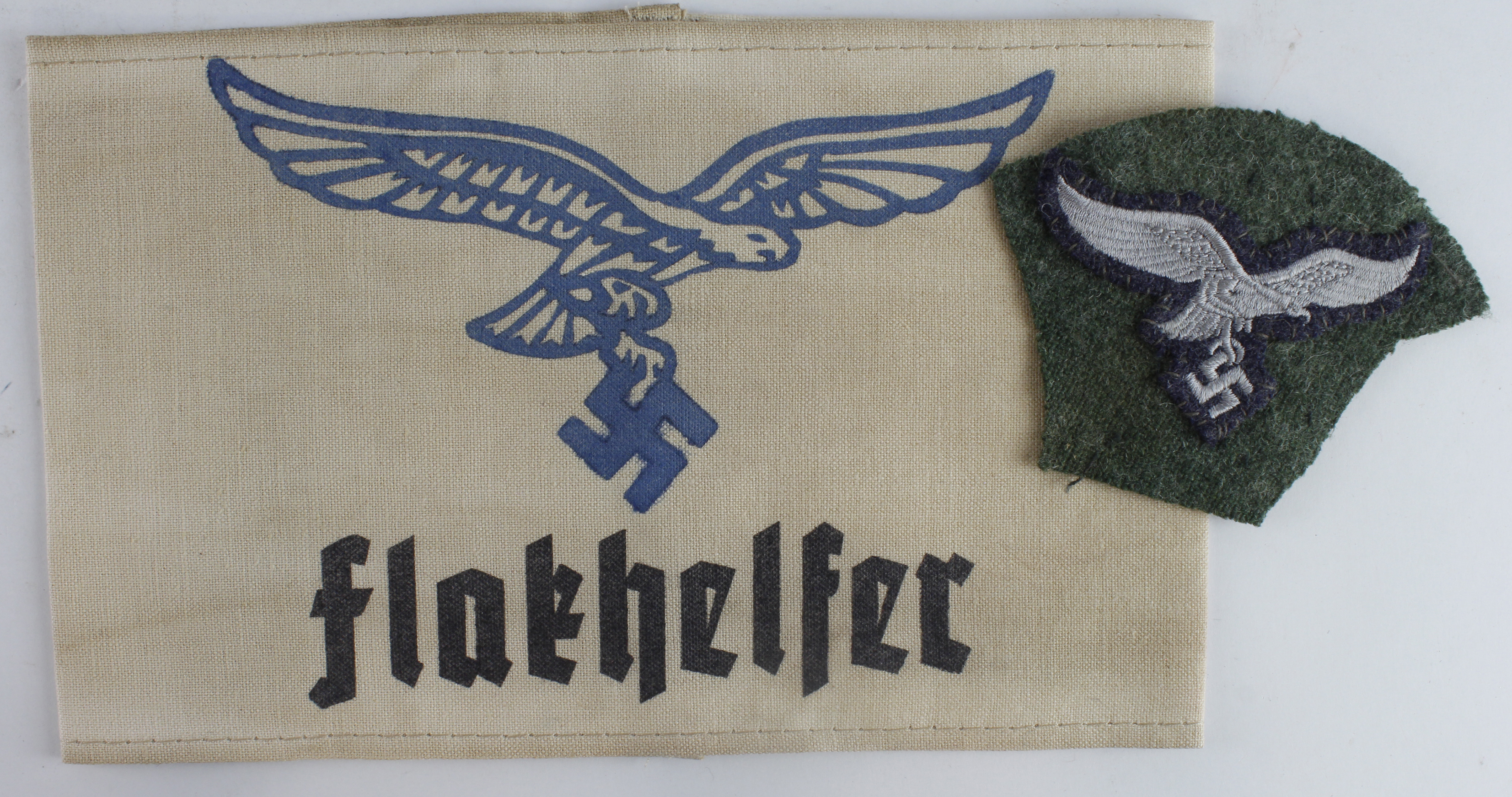 German Luftwaffe Flakhelfer arm band with Luftwaffe breast eagle cut of a uniform.