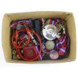 Box containing buttons, whistles, badges, medals and other collectible items.