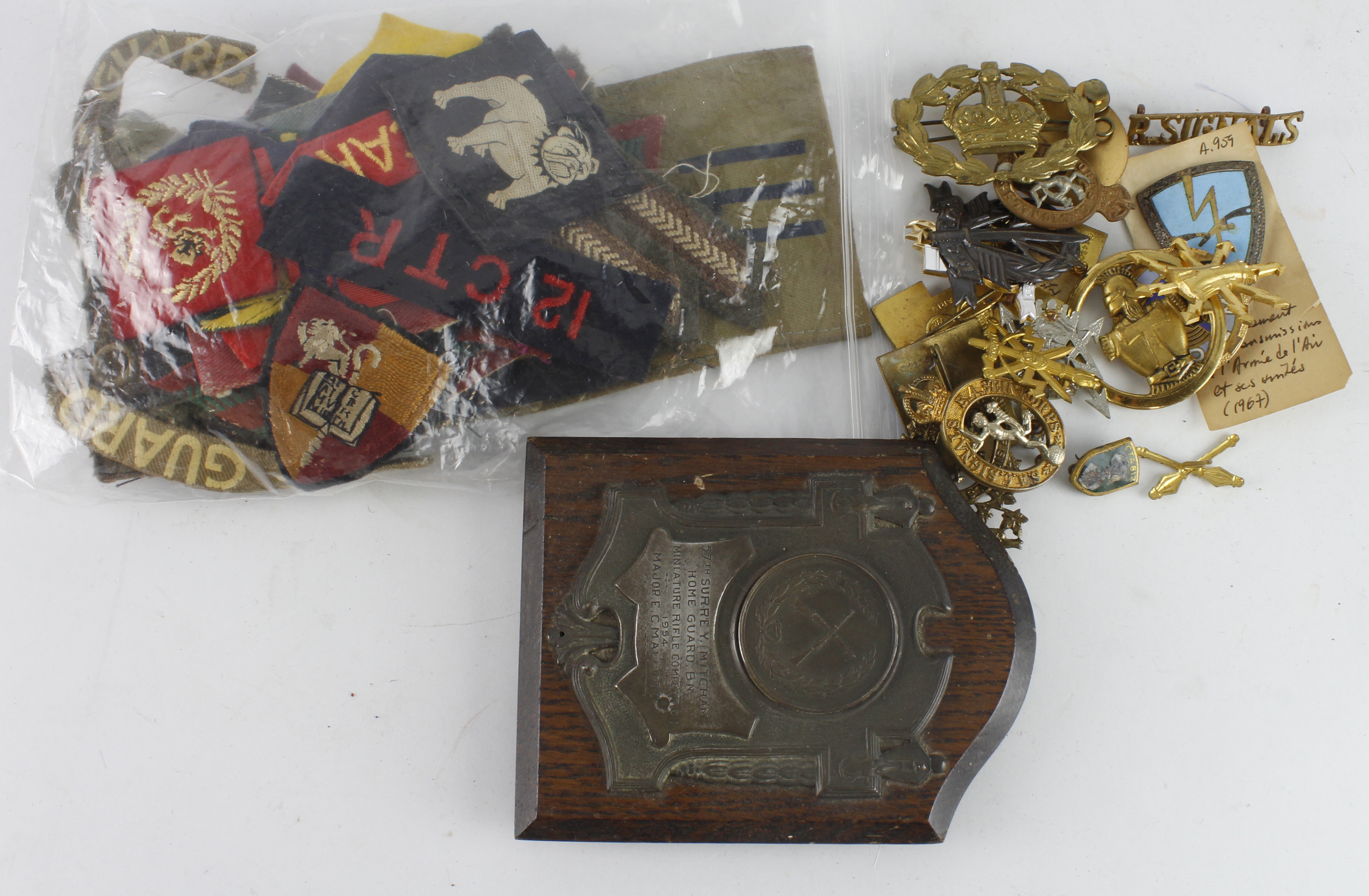 Military Badges: Assortment of metal and cloth badges, mostly British but some French and