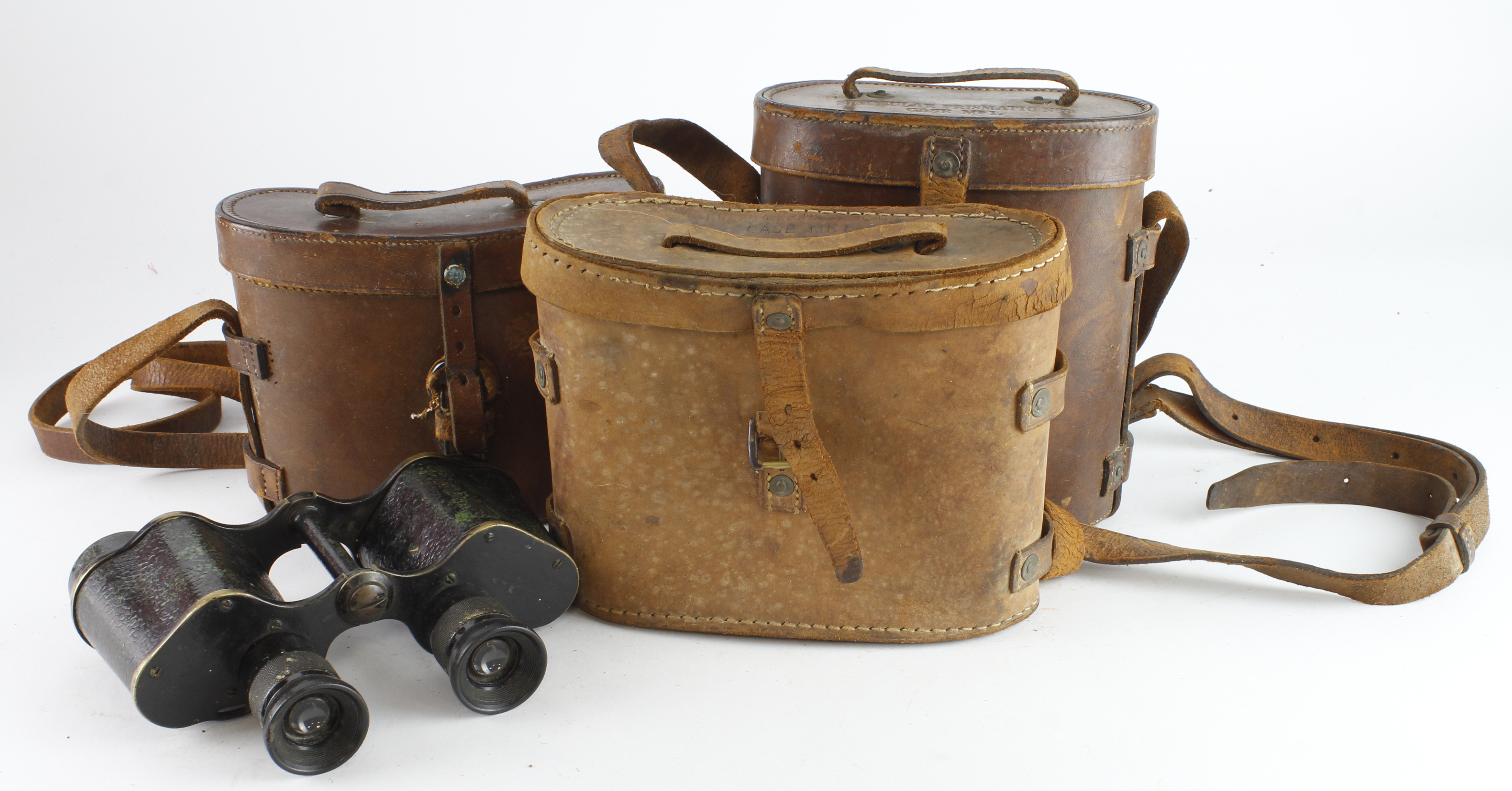 Binoculars three pairs WW1 and WW2 all in their leather cases.