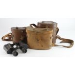 Binoculars three pairs WW1 and WW2 all in their leather cases.