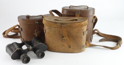 Binoculars three pairs WW1 and WW2 all in their leather cases.