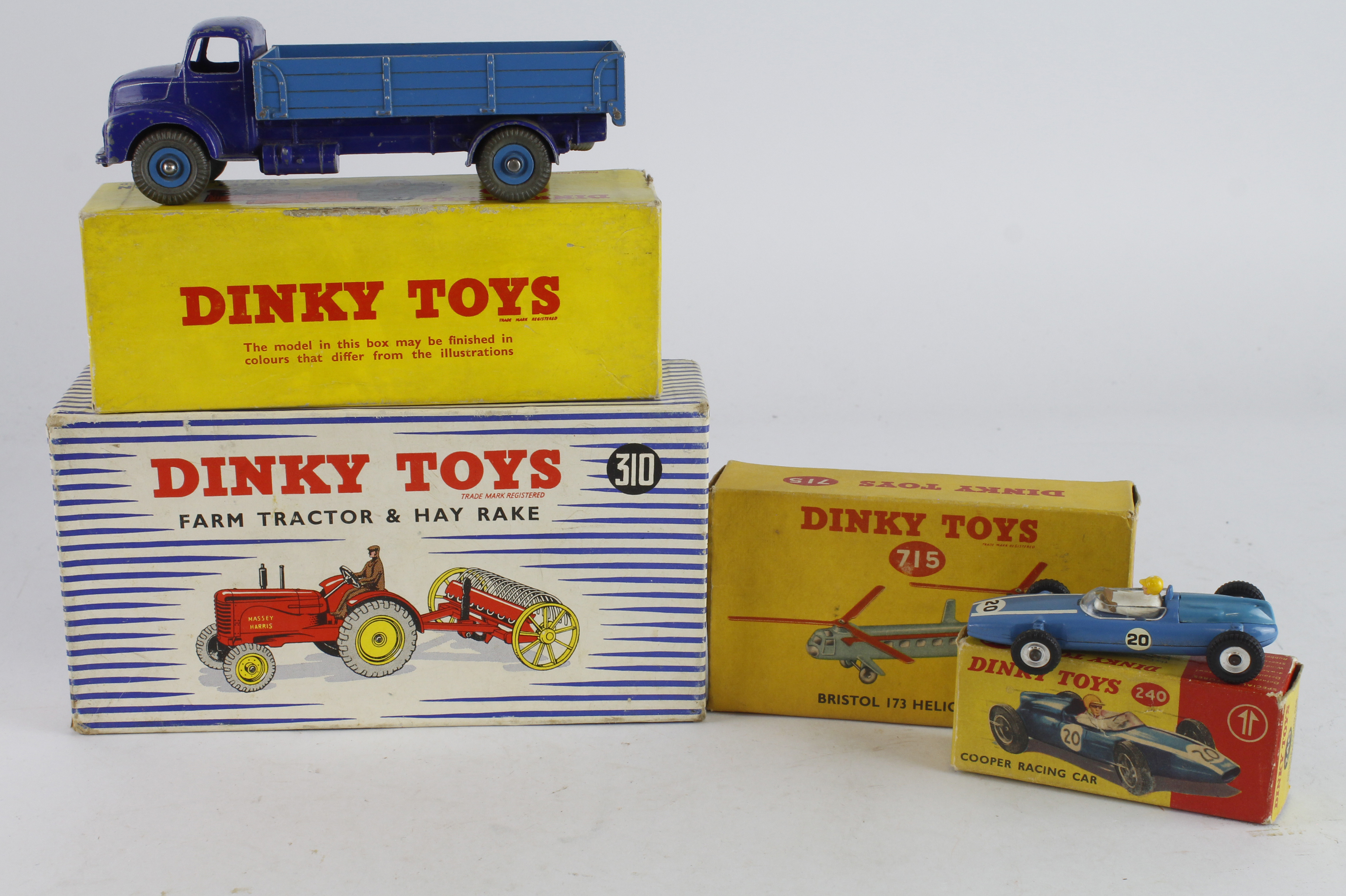 Dinky Toys. Four boxed Dinky Models, comprising Farm Tractor & Hay Rake (no. 310); Comet Wagon