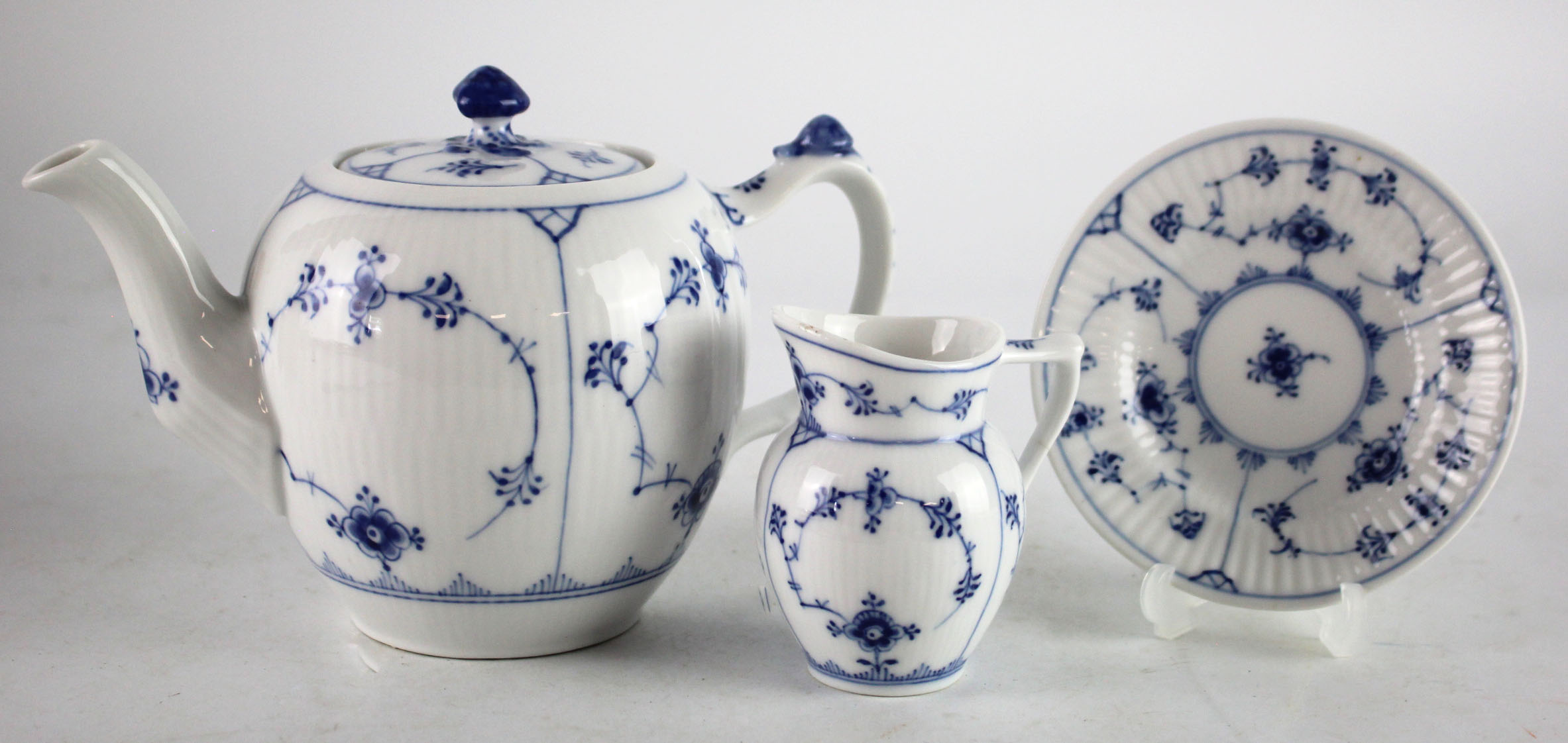 Royal Copenhagen blue fluted teapot, milk jug and small plate, makers marks to base of each,