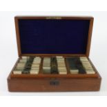 Microscope slides. A mahogany case containing approximately 60 glass slides over two layers,