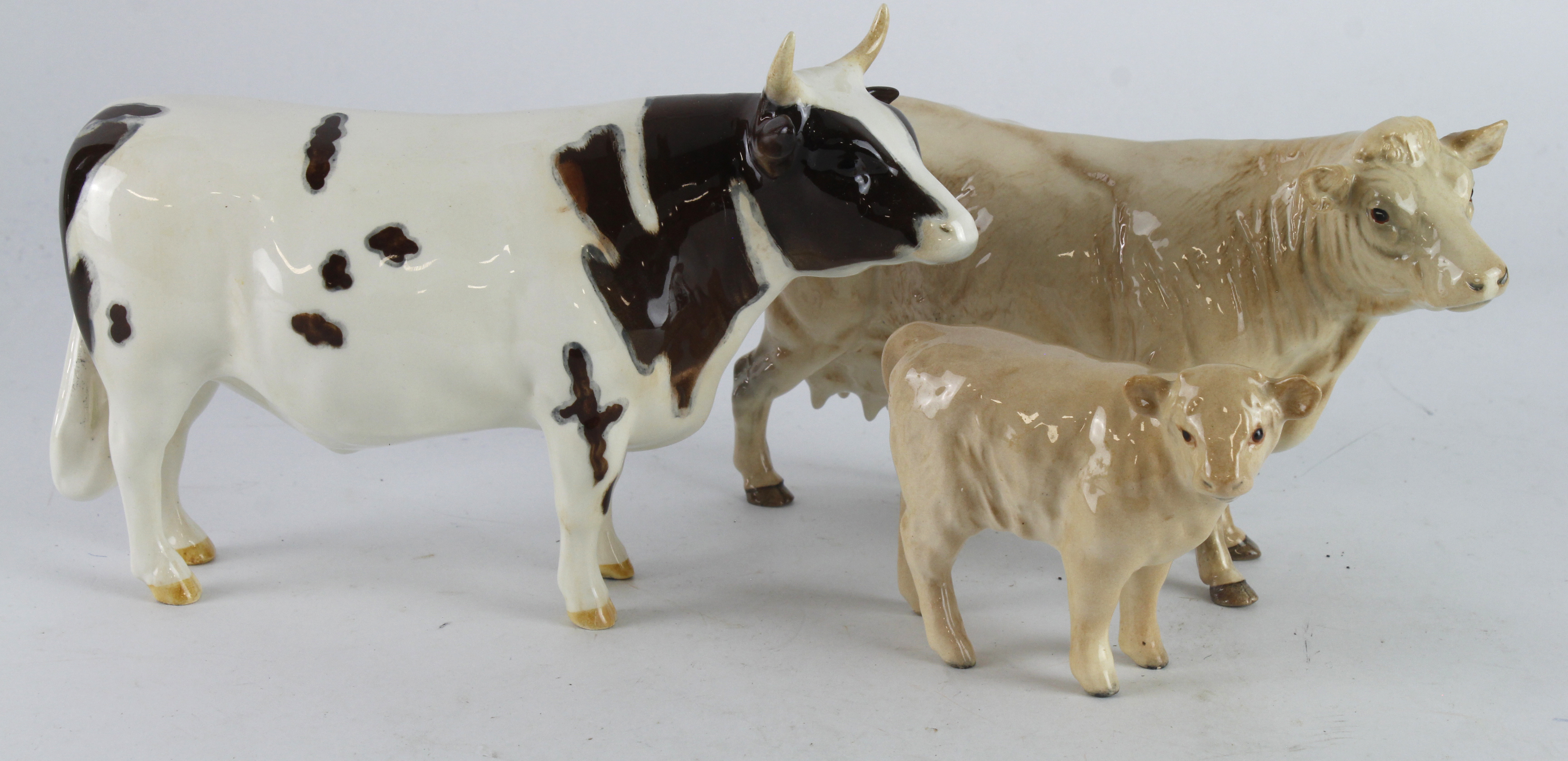 Beswick. Three Beswick figures, comprising Bull (Whitehill Mandate), Cow & Calf, tallest 13cm