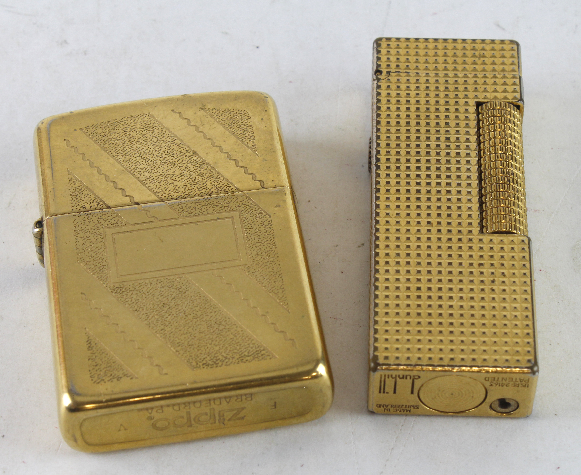 Lighters. Two gold plated lighters, comprising a Zippo & Dunhill