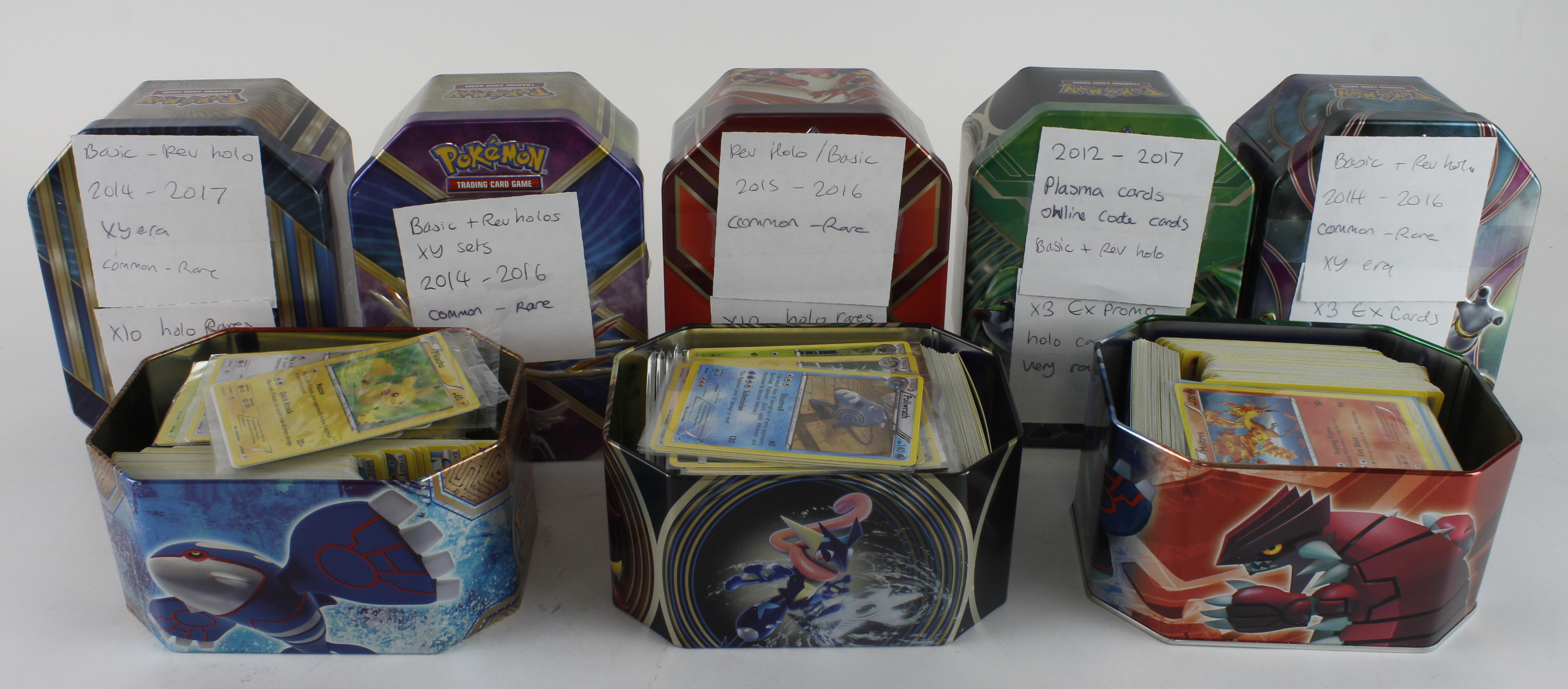 Pokemon. A collection of approximately 300 mixed Pokemon cards in tins, including holo and promo