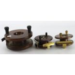 Fishing Reels. Three wooden fishing reels with brass mounts, including one stamped 'A. W. Gamage',