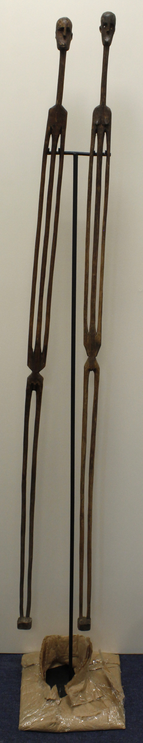 Pair of S.African hand-carved, elongated male and female figurines. Hung on a purpose made stand.