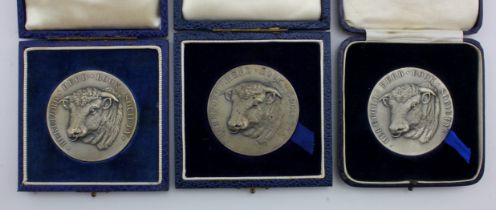 Agricultural interest. A group of three hallmarked silver Hereford Herd Book Society medallions,