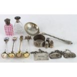 Silver & White Metal. A group of various items including silver teapoons, silver bottle labels,
