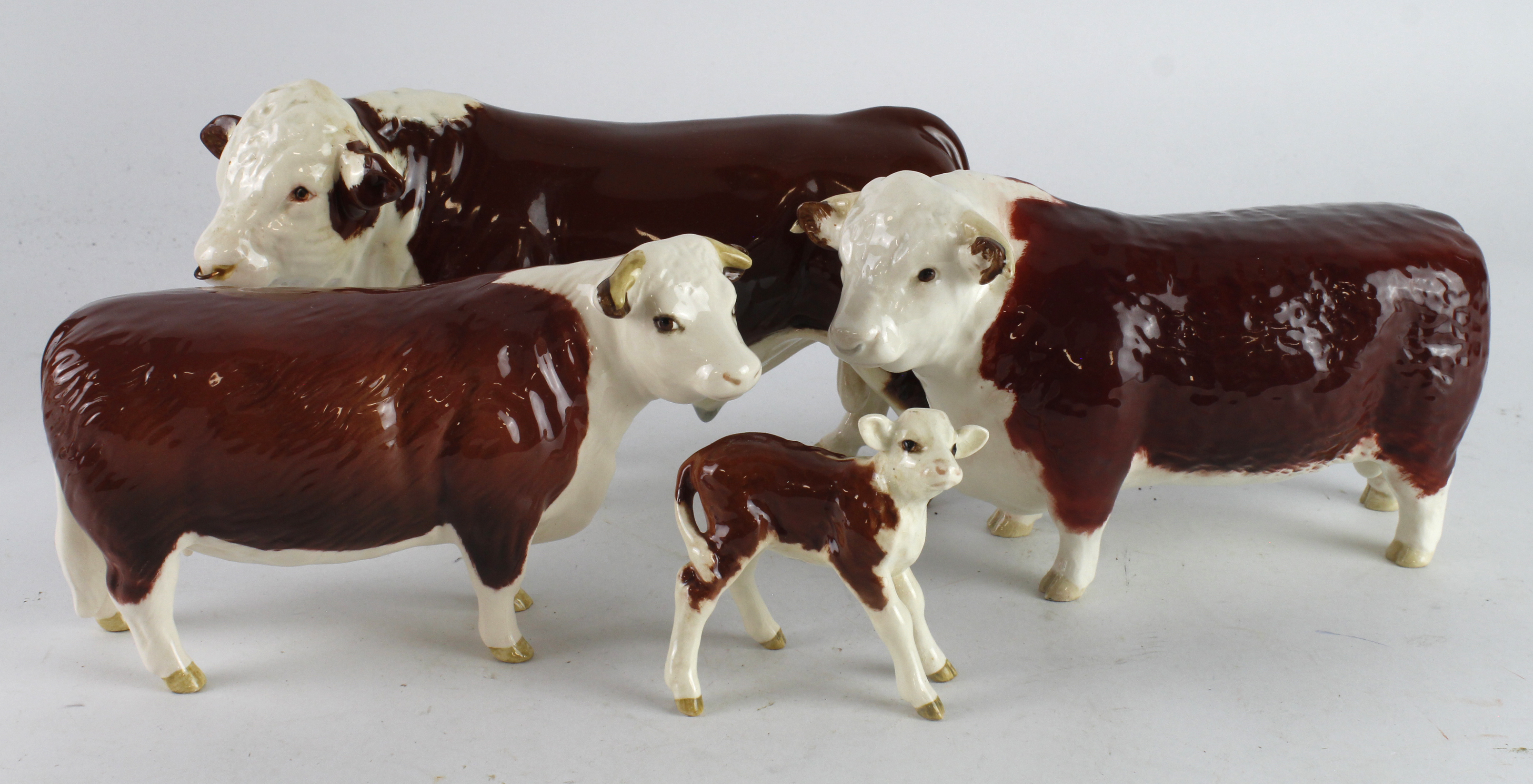 Beswick. Four Beswick figures, comprising two Hereford Bulls, Cow & Calf, tallest 13cm approx.