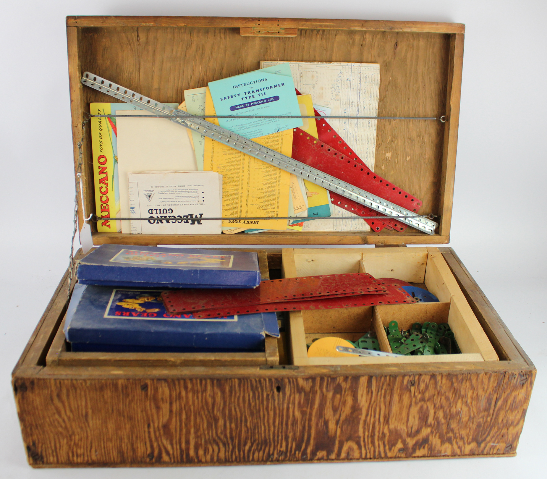 Meccano. A wooden box containing various Meccano (heavy)