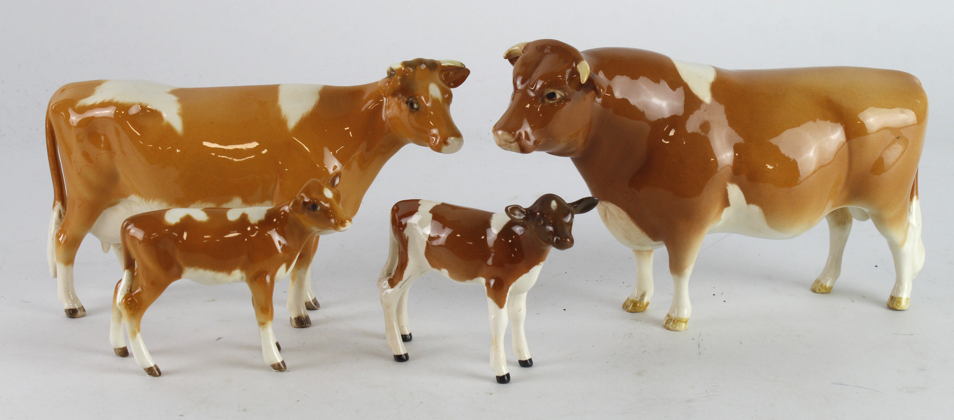 Beswick. Four Beswick figures, comprising Guernsey Bull, Cow & two Calves, tallest 10.5cm approx.